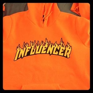 An orange Hoodie with print on the front